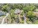 Gorgeous aerial view of a home featuring a pool and lush greenery at 401 Apache Trl, Brandon, FL 33511