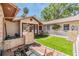 Backyard featuring artificial turf, white picket fence and water feature at 401 Apache Trl, Brandon, FL 33511