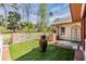 Backyard featuring artificial turf, white picket fence and water feature at 401 Apache Trl, Brandon, FL 33511