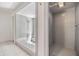 Bathroom featuring tub with showerhead and separate shower, with minimalist modern tile at 401 Apache Trl, Brandon, FL 33511