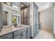 Bathroom featuring granite countertop, dual sinks, custom cabinetry, and tiled floors at 401 Apache Trl, Brandon, FL 33511
