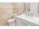 Elegant bathroom with a white vanity, granite counters, tile walls, and new toilet at 401 Apache Trl, Brandon, FL 33511