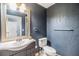 Bathroom featuring dark blue walls, patterned texture, new fixtures, and modern design at 401 Apache Trl, Brandon, FL 33511
