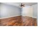 Bright bedroom with ceiling fan, wood floors, closet, and neutral paint at 401 Apache Trl, Brandon, FL 33511