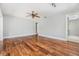 Neutral bedroom with wood floors, a ceiling fan, and access to other rooms at 401 Apache Trl, Brandon, FL 33511