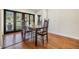 Bright dining room features hardwood floors, a dark wood table, and views of the landscaped backyard at 401 Apache Trl, Brandon, FL 33511
