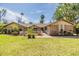 Spacious front yard with lush grass and manicured landscaping, creating curb appeal at 401 Apache Trl, Brandon, FL 33511