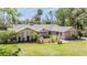 Charming single-story home featuring a well-maintained lawn and beautiful landscaping at 401 Apache Trl, Brandon, FL 33511