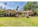 Landscaped front yard featuring a well-maintained lawn and established trees at 401 Apache Trl, Brandon, FL 33511