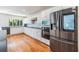 Bright kitchen features stainless steel appliances, white cabinets, and tile backsplash at 401 Apache Trl, Brandon, FL 33511