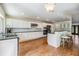 Kitchen with white cabinets, stainless steel appliances, granite countertops, and a breakfast bar at 401 Apache Trl, Brandon, FL 33511