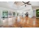 Open-concept living room with hardwood floors, a kitchen, and sliding doors to an outdoor area at 401 Apache Trl, Brandon, FL 33511