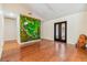 Spacious living area boasting hardwood flooring, recessed lighting and a unique green decorative wall at 401 Apache Trl, Brandon, FL 33511