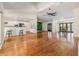 Bright living room with hardwood floors, a kitchen, and dining area visible in an open-concept layout at 401 Apache Trl, Brandon, FL 33511