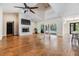 Bright living room boasts hardwood floors, brick fireplace, vaulted ceilings, and pool views at 401 Apache Trl, Brandon, FL 33511