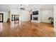 Spacious living room with hardwood floors, a fireplace, and a view to the outside through large windows at 401 Apache Trl, Brandon, FL 33511