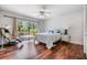 Bright main bedroom with wood floors, ceiling fan, sliding glass doors to deck at 401 Apache Trl, Brandon, FL 33511