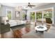 Bright main bedroom with hardwood floors and a sliding glass door leading to the pool at 401 Apache Trl, Brandon, FL 33511