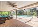 Screened-in patio features brick flooring, plenty of seating, and a view of the gorgeous pool at 401 Apache Trl, Brandon, FL 33511