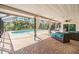 Outdoor patio area featuring brick flooring and a luxurious pool perfect for relaxing or entertaining at 401 Apache Trl, Brandon, FL 33511