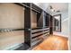 Large walk-in closet with custom organizers, drawers, and hardwood flooring at 401 Apache Trl, Brandon, FL 33511