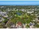 Aerial view of a home near a pond surrounded by lush trees in a neighborhood at 427 5Th Nw St, Largo, FL 33770