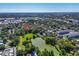 Aerial view of a home near a pond and grassy field amidst a neighborhood at 427 5Th Nw St, Largo, FL 33770