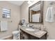 Well-lit bathroom featuring a granite vanity and a large decorative mirror at 427 5Th Nw St, Largo, FL 33770