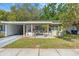 Charming single-story home featuring a carport, neutral paint scheme, and inviting landscaping at 427 5Th Nw St, Largo, FL 33770