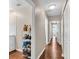 Long hallway with hardwood floors and a laundry area at 427 5Th Nw St, Largo, FL 33770
