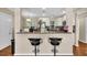 Bright kitchen with white cabinets, stainless steel appliances, and a breakfast bar at 427 5Th Nw St, Largo, FL 33770