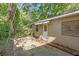 Back patio with brick pavers, foliage and mature trees at 427 5Th Nw St, Largo, FL 33770