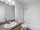 Bright bathroom featuring vanity with tub-shower combo and white tile surround at 4426 Brandon Ridge Dr, Valrico, FL 33594