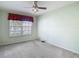 Bedroom features natural light from a window and standard ceiling fan at 4426 Brandon Ridge Dr, Valrico, FL 33594