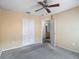 Bedroom with carpet flooring, a ceiling fan, double-door closet and entrance to a bathroom at 4426 Brandon Ridge Dr, Valrico, FL 33594