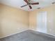Bedroom with closet and a ceiling fan featuring carpet floors and beige walls at 4426 Brandon Ridge Dr, Valrico, FL 33594