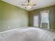 Spacious bedroom with carpeted floors, a ceiling fan and back yard access at 4426 Brandon Ridge Dr, Valrico, FL 33594