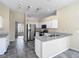 Spacious kitchen boasts stainless steel appliances, tile floors, and great counter space at 4426 Brandon Ridge Dr, Valrico, FL 33594