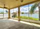 Screened lanai with ceiling fan and view of backyard and fence, perfect for outdoor living at 4426 Brandon Ridge Dr, Valrico, FL 33594