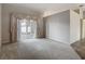 Spacious living room with neutral carpeting and sliding glass doors to the outside at 4426 Brandon Ridge Dr, Valrico, FL 33594