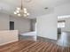 Open living room showcasing hardwood floors, a chandelier, and view of the kitchen at 4426 Brandon Ridge Dr, Valrico, FL 33594