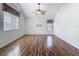 A spacious living room with lots of natural light from two windows and hard wood floors at 4426 Brandon Ridge Dr, Valrico, FL 33594