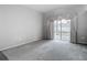 Bright living room featuring neutral carpet and sliding glass doors to the lanai at 4426 Brandon Ridge Dr, Valrico, FL 33594