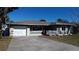 Inviting single-story home featuring a well-maintained lawn, attached garage and ample parking at 447 80Th Ave, St Pete Beach, FL 33706