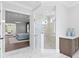 Bathroom featuring marble shower, wood floors, and views into a spacious and bright main bedroom at 4614 W Lowell Ave, Tampa, FL 33629