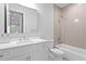 Bright bathroom features a tub, and a vanity with a white countertop and tiled backsplash at 4614 W Lowell Ave, Tampa, FL 33629