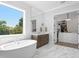 Bright bathroom features a soaking tub with a large window and a spacious walk-in closet at 4614 W Lowell Ave, Tampa, FL 33629