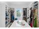 Walk-in closet with custom shelves, drawers, and a center island at 4614 W Lowell Ave, Tampa, FL 33629