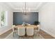 Stylish dining room with modern lighting, hardwood floors, and a statement accent wall at 4614 W Lowell Ave, Tampa, FL 33629