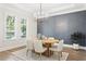 Dining room featuring modern chandelier, gray accent wall, and lots of natural light at 4614 W Lowell Ave, Tampa, FL 33629